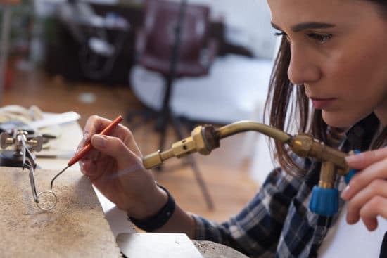 A girl making jewelry.