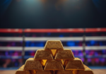 Gold bars stacked inside a boxing ring symbolizing the Federal Reserve meeting impact on gold and silver prices